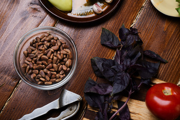 ingredients for pesto sauce with pine nuts  laying at wooden table