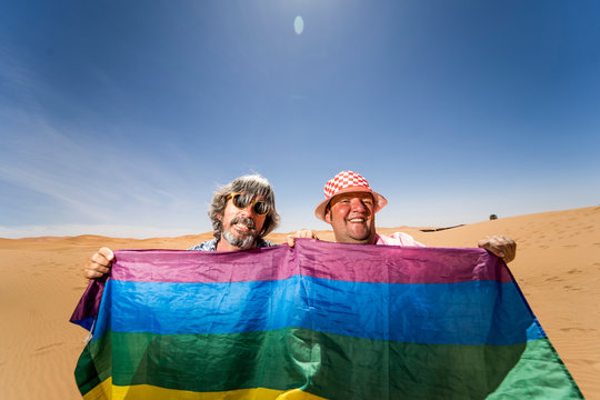 Excited plump gay couple in desert