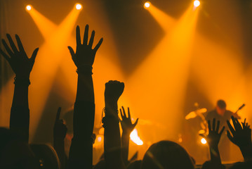Hands of the crowd raised up at music concert