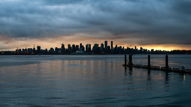 Panoramic view of Downtown City Skyline during a striking and dramatic sunset. Taken in Lonsdale, North Vancouver, BC, Canada. Still Image Continuous Animation