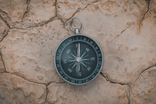 From above big round compass pointing to north on desert place in semi-desert Bardenas Reales Navarra Spain