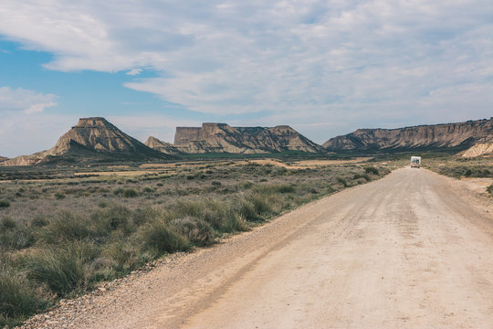 White trailer on empty road along desert