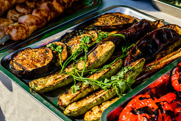 Grilled eggplants and marrows in a metal tray