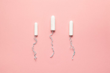 Unpacked different sizes tampons on a soft pink background. Modern female intimate gynecological hygiene. Eco zero waste concept. Copy spase place for text. Flat lay