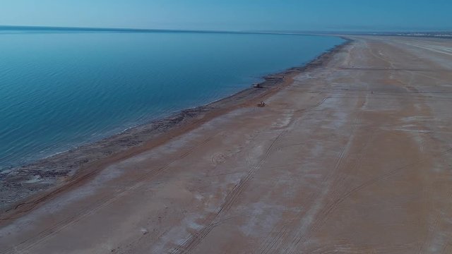 Sea foam at the beach of the Aral Sea near Aktumsuk cape at sunset in Karakalpakstan, Uzbekistan.