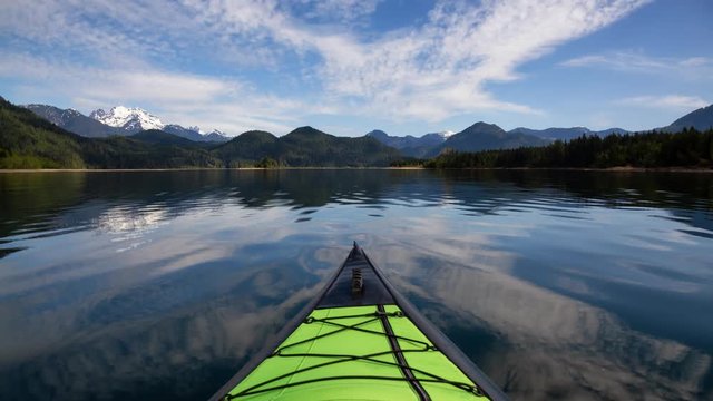 Kayaking during a beautiful morning surrounded by the Canadian Mountain Landscape. Taken in Stave Lake, East of Vancouver, British Columbia, Canada. Still Image Continuous Animation