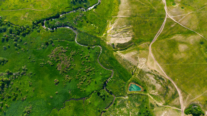  Aerial view from the drone of summer landscape with river, hills and forests.