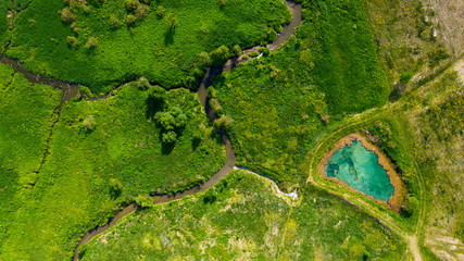 Aerial view from the drone of the landscape of blue mineral lake with clear water. Russia, Samara region, Blue lake.