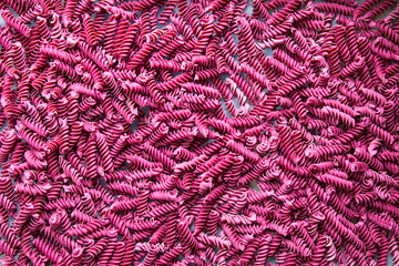 Red spiral macaroni.The color is made of beetroot