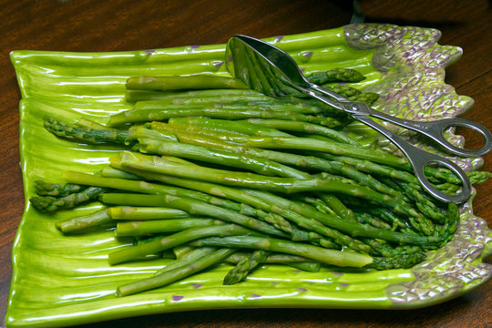 Cooked fresh asparagus on an asparagus serving dish. St Paul Minnesota MN USA