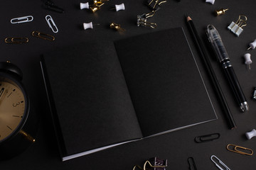 layout, black notebook with accessories on a black background, design. Black branding mockup