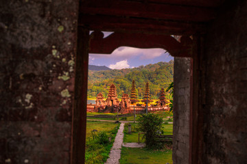 View through a doorway towards Pura Ulun Danu Tamblingan temple in the Buleleng Regency area of Bali, Indonesia