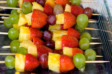 Delicious party tray of skewered fruit consisting of grapes pineapple and strawberries. St Paul...