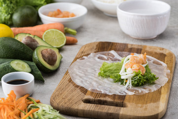 lettuce, noodles and shrimps on rice paper, on cutting board