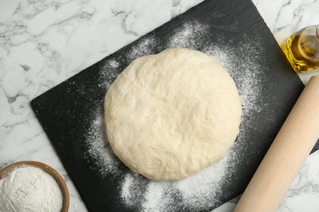 Flat lay composition with ingredients for bread on marble background