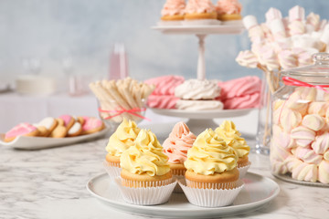 Candy bar with different sweets on white marble table. Space for text
