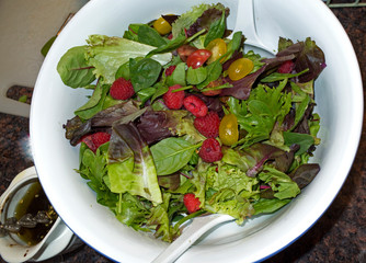 Healthy lettuce salad garnished with red raspberries and tomatoes. St Paul Minnesota MN USA