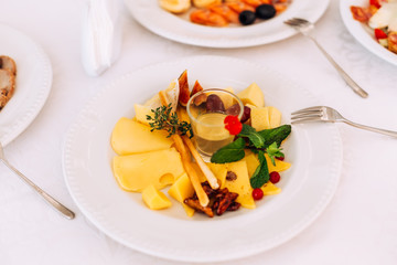  Delicious dishes on the table in the restaurant. sliced cheese