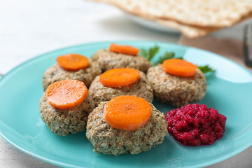 Plate of traditional Passover (Pesach) gefilte fish on table, closeup
