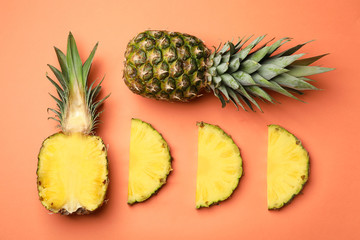 Flat lay composition with cut and fresh juicy pineapples on color background
