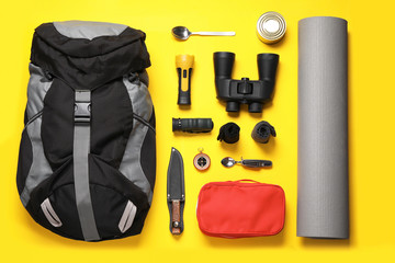 Flat lay composition with different camping equipment on color background