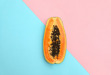 Fresh juicy halved papaya on color background, top view. Space for text
