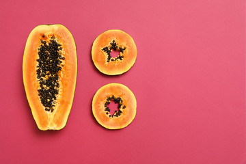 Flat lay composition with cut papaya on pink background, space for text