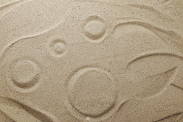 Patterns drawn on yellow sand