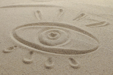 Fototapeta na wymiar Eye drawn on sand.Mystery concept
