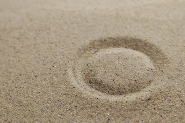 Patterns drawn on yellow sand