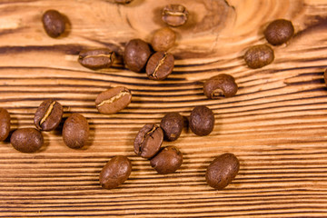 Scattered coffee beans on a wooden table. Top view