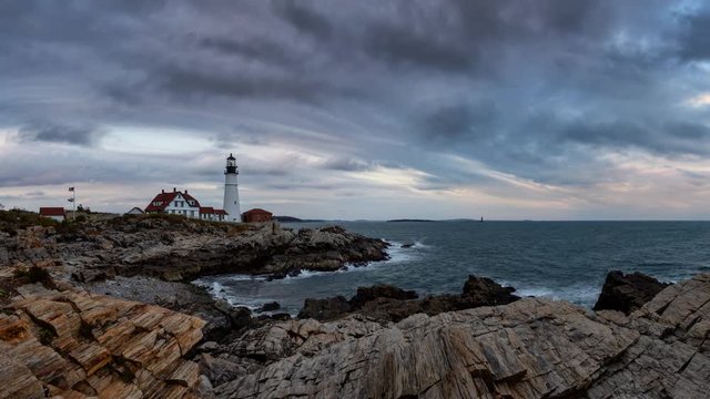 Beautiful view of Portland Head Lighthouse on the Atlantic Ocean Coast during cloudy sunset. Taken in Fort Williams Park, Portland, Maine, United States. Still Image Continuous Animation