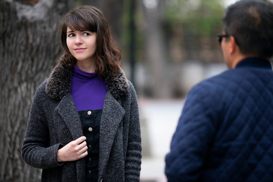 Woman walking outdoors in the city and looking snobby while running into an ex boyfriend or looking annoyed by an insulting stranger.  It also depicts social anxiety.