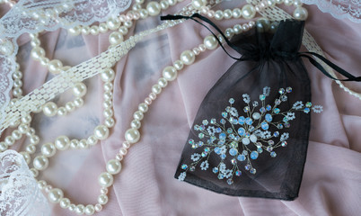 Wedding background with pearls and hair accessories on pink background