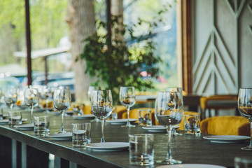 Glass goblets on the table. Served table. Table setting