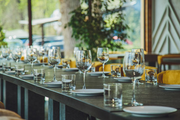 Glass goblets on the table. Served table. Table setting