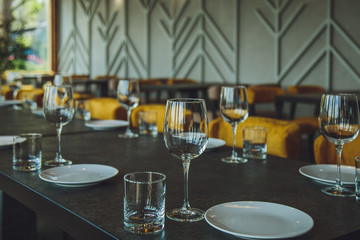 Glass goblets on the table. Served table. Table setting