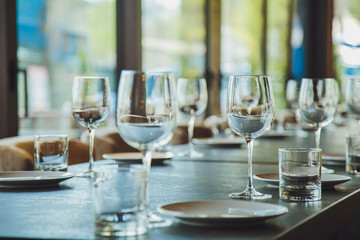 Glass goblets on the table. Served table. Table setting