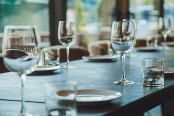 Glass goblets on the table. Served table. Table setting