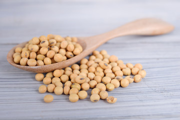 soybean on wooden spoon and on wooden background
