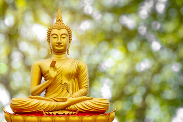 Golden Buddha image under the Bodhi leaf, natural background
