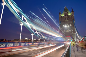 Vehicles pass over Tower Bridge across the River Thames in London, UK.