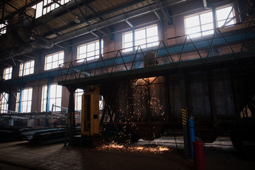 people while working in a large factory.railway plant