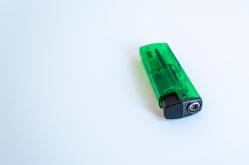 Perspective open shoot of transparent horizontal green lighter on white surface