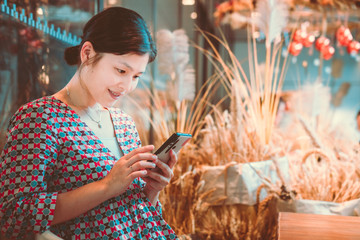 Woman using smartphone in cafe shop