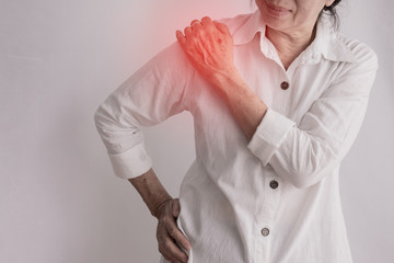 asian elderly woman having Shoulder pain on isolated white background.
