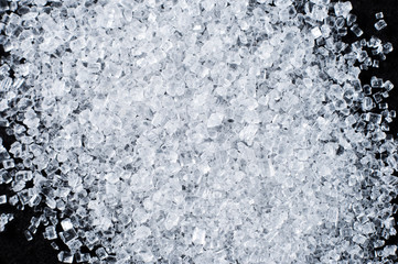 White salt in crystals on a dark background