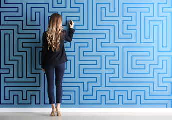 Woman in formal clothes drawing on color wall. Concept of business plan development - obrazy, fototapety, plakaty