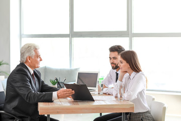 Couple meeting with notary public in office