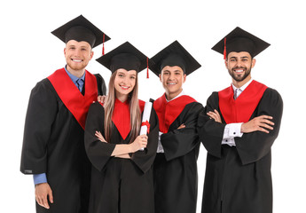 Young students in bachelor robes on white background